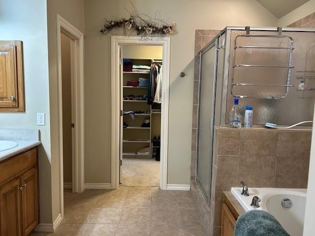 bathroom with vanity, tile patterned flooring, and shower with separate bathtub