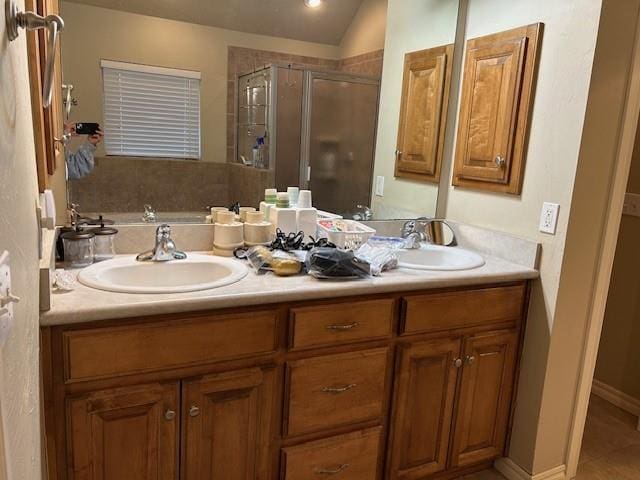 bathroom with walk in shower, lofted ceiling, and vanity