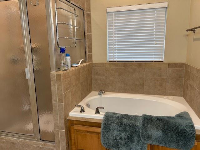 bathroom with shower with separate bathtub