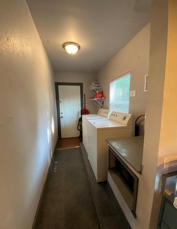 washroom with washing machine and clothes dryer