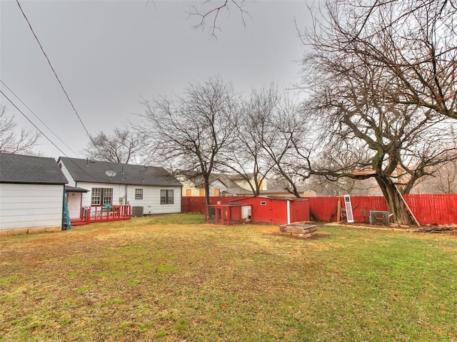 view of yard featuring a fire pit and central air condition unit