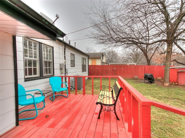 wooden deck with central air condition unit and a lawn