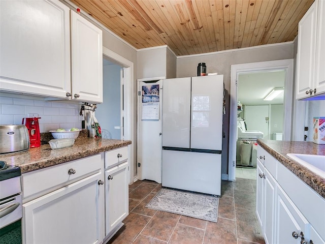 kitchen with white cabinetry, backsplash, white refrigerator, crown molding, and wooden ceiling