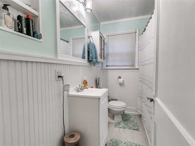 bathroom with vanity, ornamental molding, and toilet