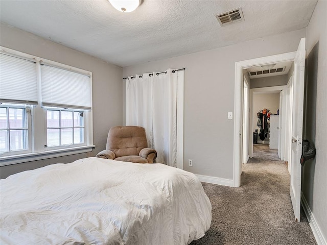 bedroom with carpet and a textured ceiling