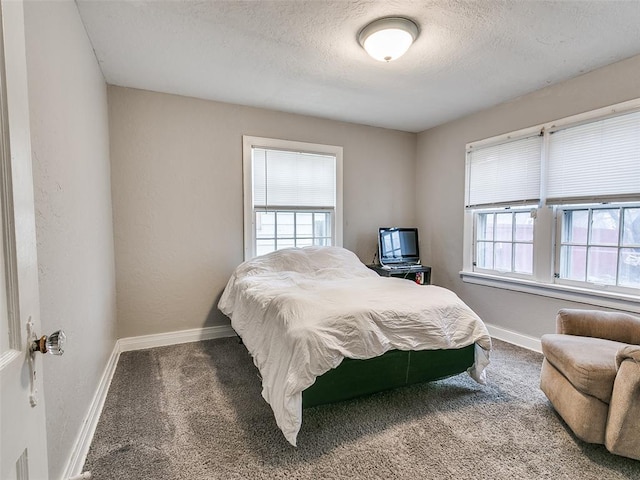 carpeted bedroom featuring a textured ceiling