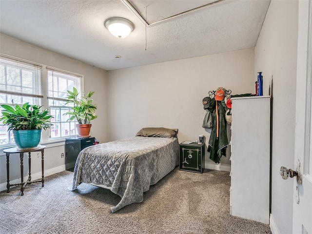 carpeted bedroom featuring a textured ceiling