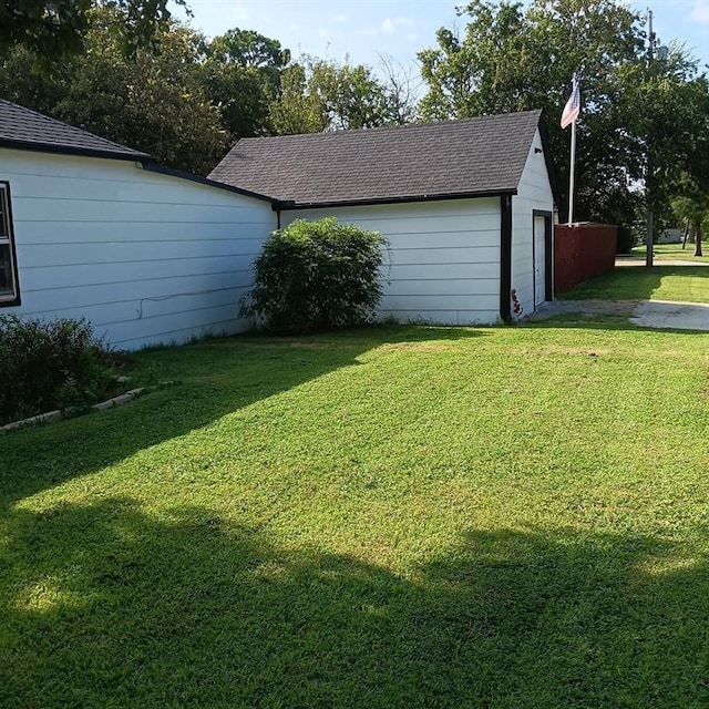 exterior space with a garage and a yard