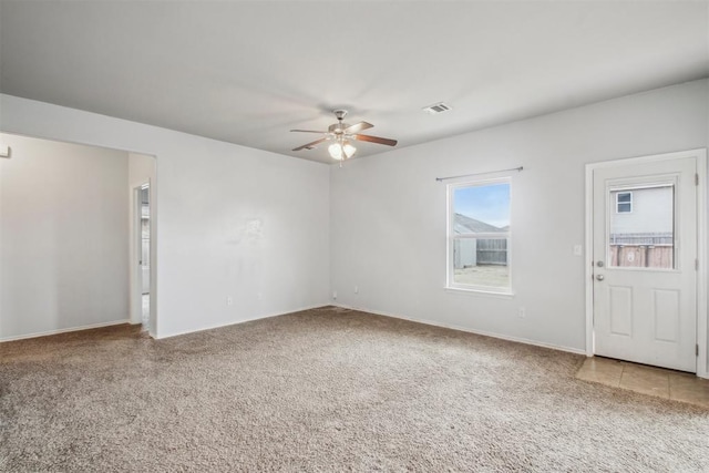 carpeted spare room with ceiling fan