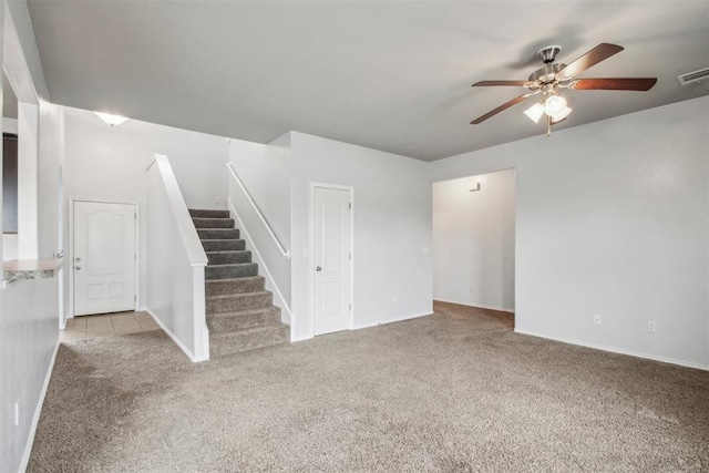 unfurnished living room with light colored carpet and ceiling fan