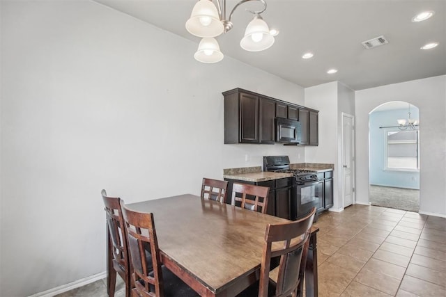 tiled dining area featuring a notable chandelier