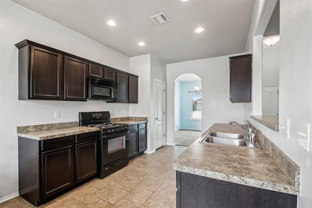 kitchen with dark brown cabinetry, sink, and black appliances