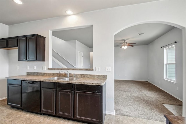 kitchen featuring black dishwasher, sink, light colored carpet, and ceiling fan