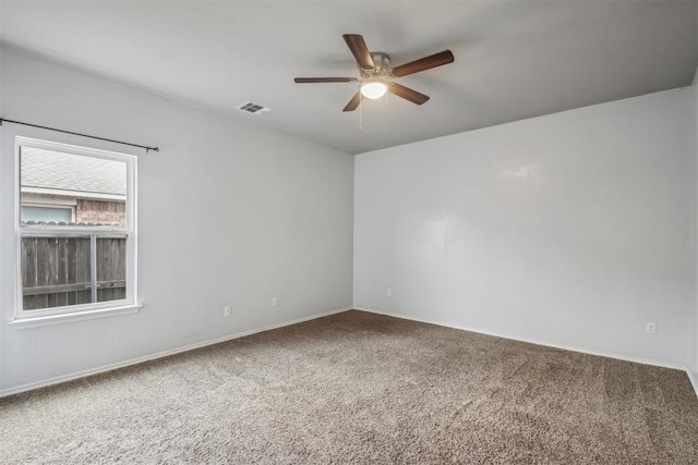 carpeted spare room featuring ceiling fan