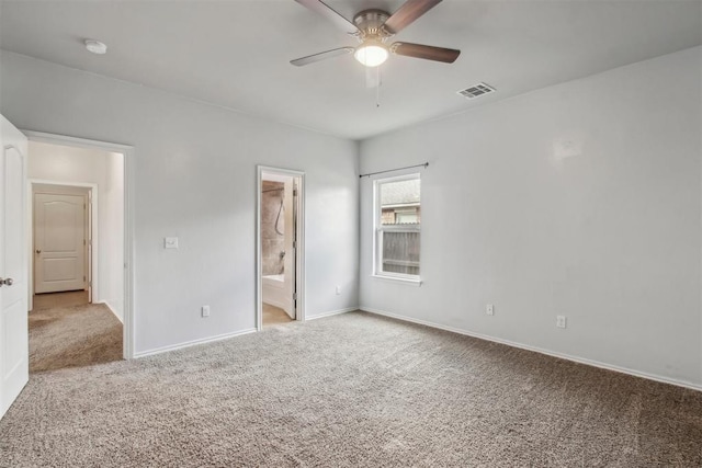 unfurnished bedroom featuring connected bathroom, light carpet, and ceiling fan