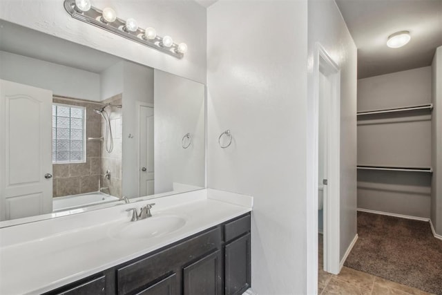 bathroom with tiled shower / bath and vanity