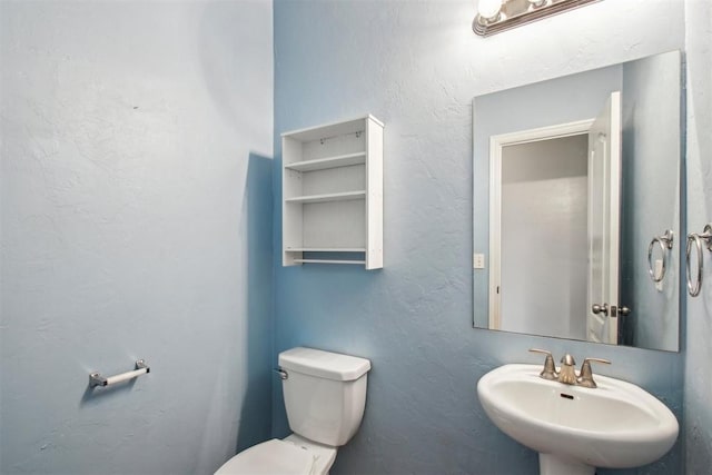 bathroom with sink and toilet