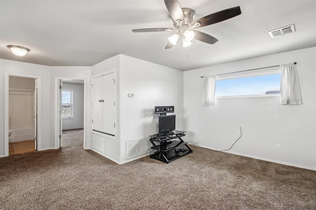 interior space with carpet and ceiling fan