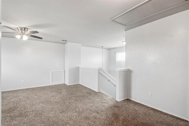 spare room with ceiling fan and carpet