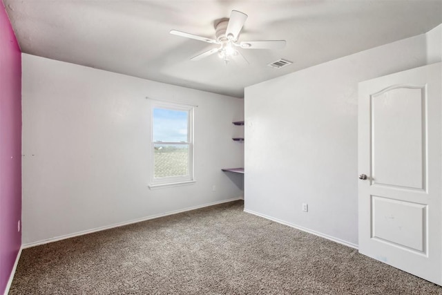 carpeted spare room with ceiling fan