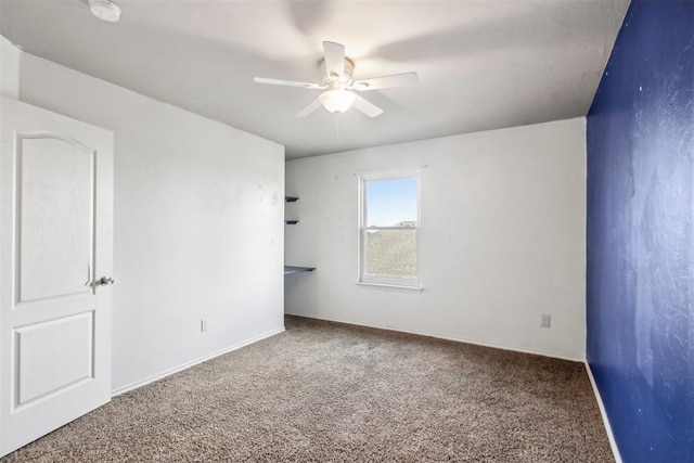 empty room with ceiling fan and carpet floors