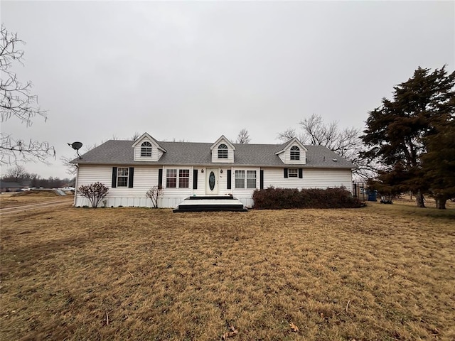 cape cod-style house with a front yard