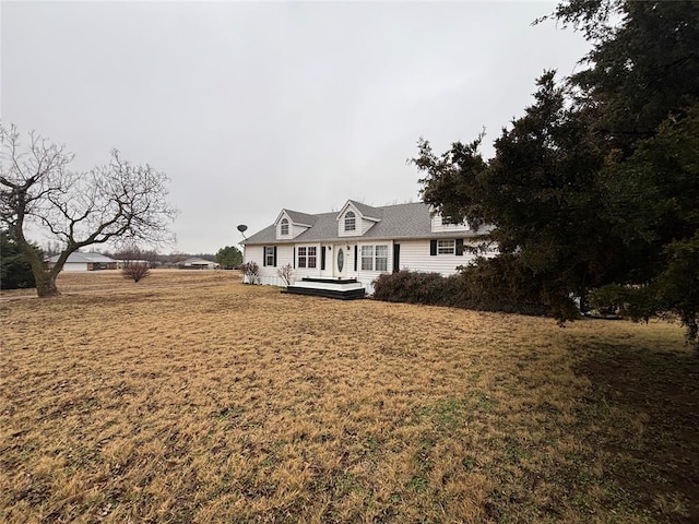 view of front of property with a wooden deck and a front yard