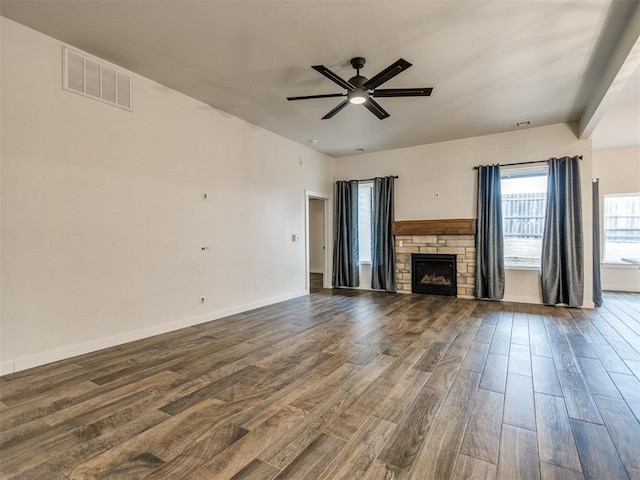 unfurnished living room featuring hardwood / wood-style flooring, ceiling fan, and a fireplace