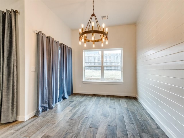 interior space featuring wood-type flooring and a notable chandelier