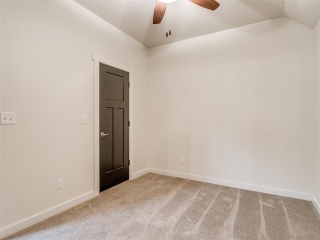 unfurnished room featuring ceiling fan, vaulted ceiling, and carpet