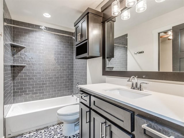 full bathroom with tiled shower / bath, vanity, toilet, and tile patterned floors