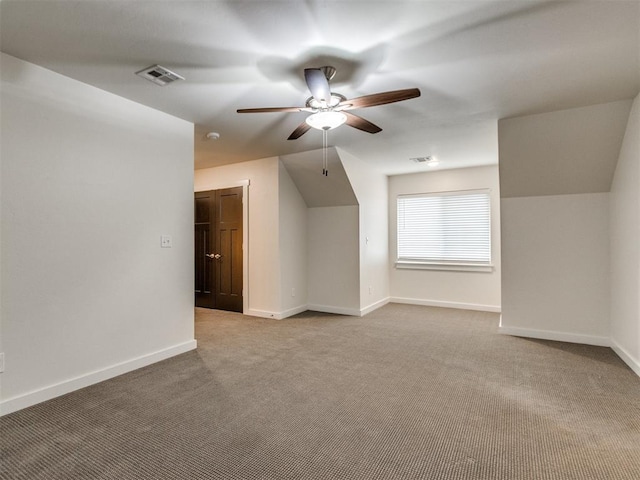 additional living space with vaulted ceiling, ceiling fan, and carpet