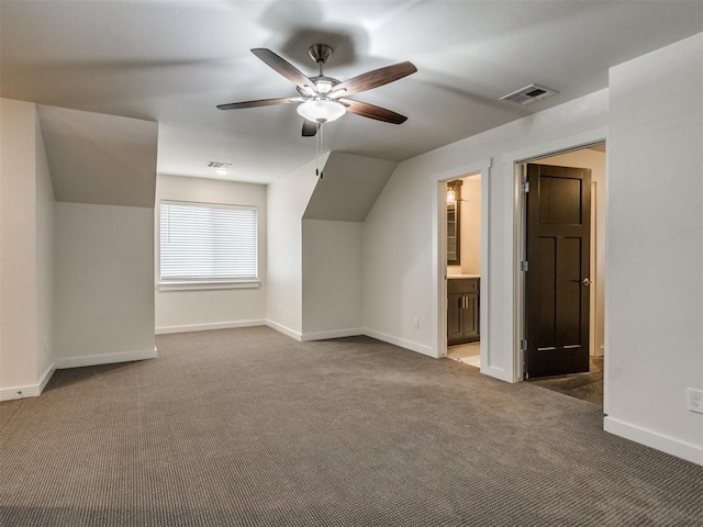 additional living space with vaulted ceiling, ceiling fan, and carpet