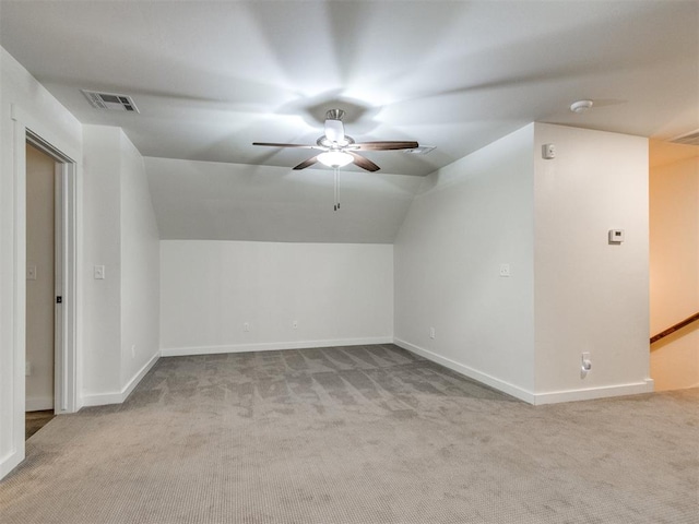 additional living space featuring vaulted ceiling, light colored carpet, and ceiling fan