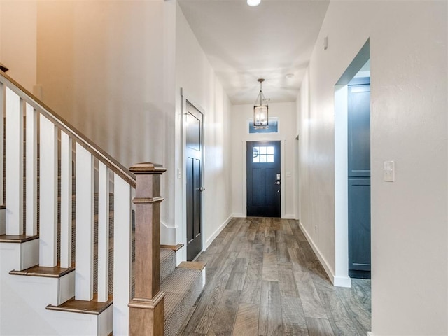 8909 NW 129th St, Oklahoma City, OK 73142 - entryway featuring wood finished floors, stairs, a chandelier, and baseboards