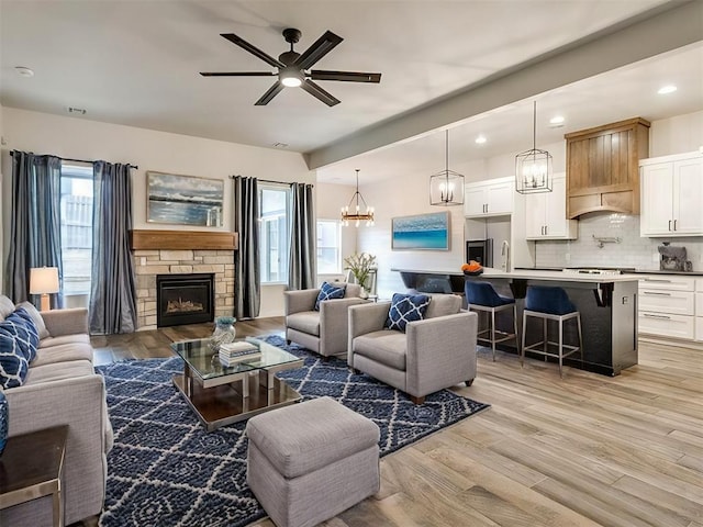 8909 NW 129th St, Oklahoma City, OK 73142 - living area with a chandelier, light wood-type flooring, recessed lighting, a fireplace, and a ceiling fan