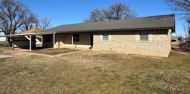 back of house featuring a carport and a lawn