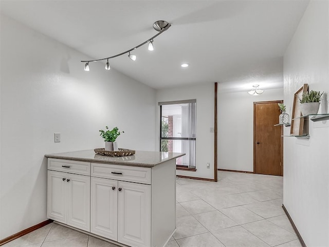 kitchen with white cabinetry and light tile patterned floors