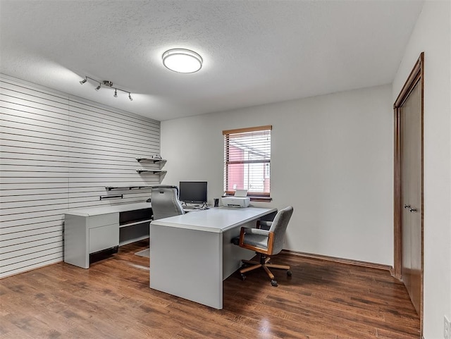 office space with dark hardwood / wood-style floors and a textured ceiling