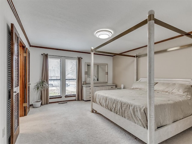 carpeted bedroom with ornamental molding