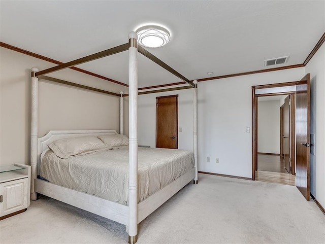 bedroom with ornamental molding and light carpet