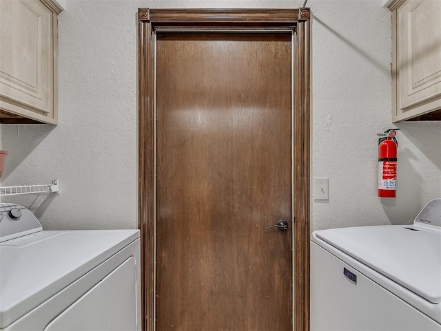 washroom featuring cabinets and washing machine and dryer