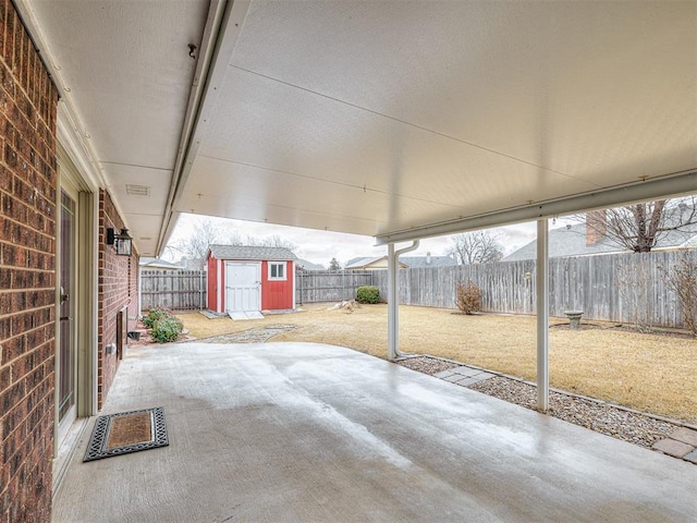 view of patio with a storage shed