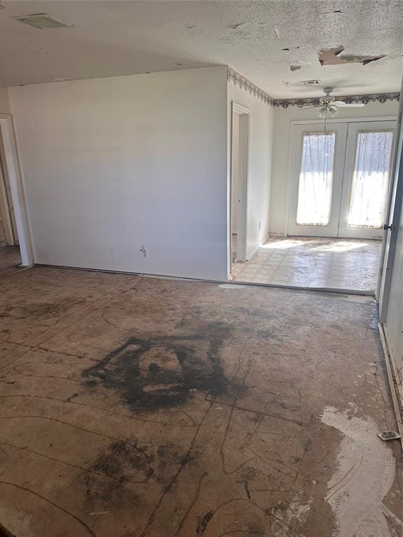 unfurnished room with visible vents and a textured ceiling