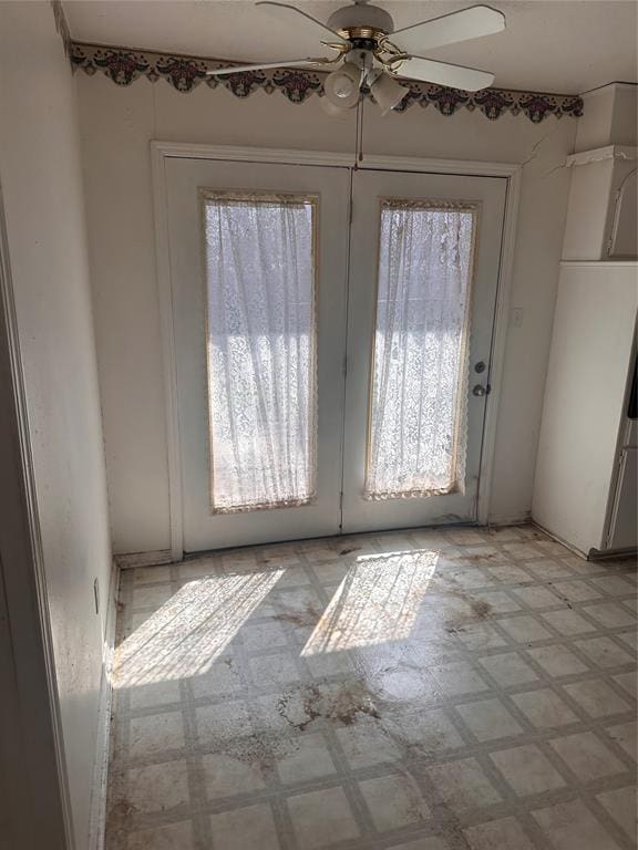 interior space featuring light floors and ceiling fan