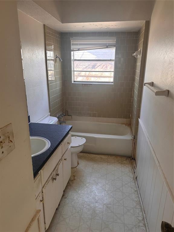 bathroom featuring vanity, toilet, and shower / bathtub combination