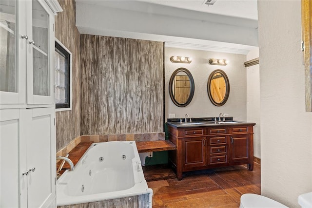 bathroom with hardwood / wood-style flooring, vanity, toilet, and a tub