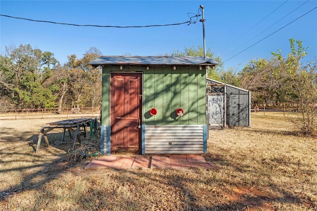 view of outbuilding featuring a lawn