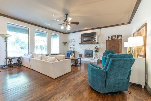 living room with crown molding, a fireplace, dark hardwood / wood-style flooring, and ceiling fan