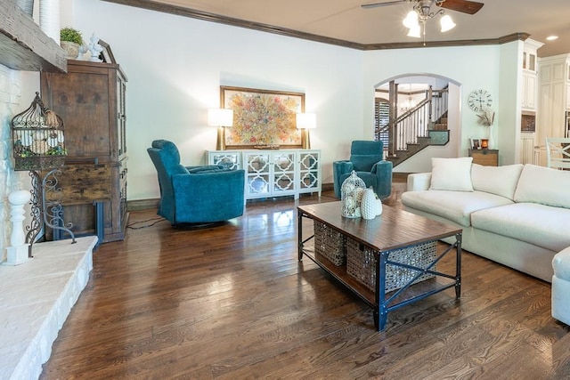 living room featuring dark hardwood / wood-style flooring, crown molding, and ceiling fan